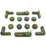 Set of various small garden beds with plants on a white background 