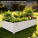 White raised garden bed with plants and flowers on a grassy lawn 