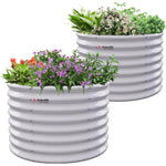 Two white ribbed planters with plants on a white background 