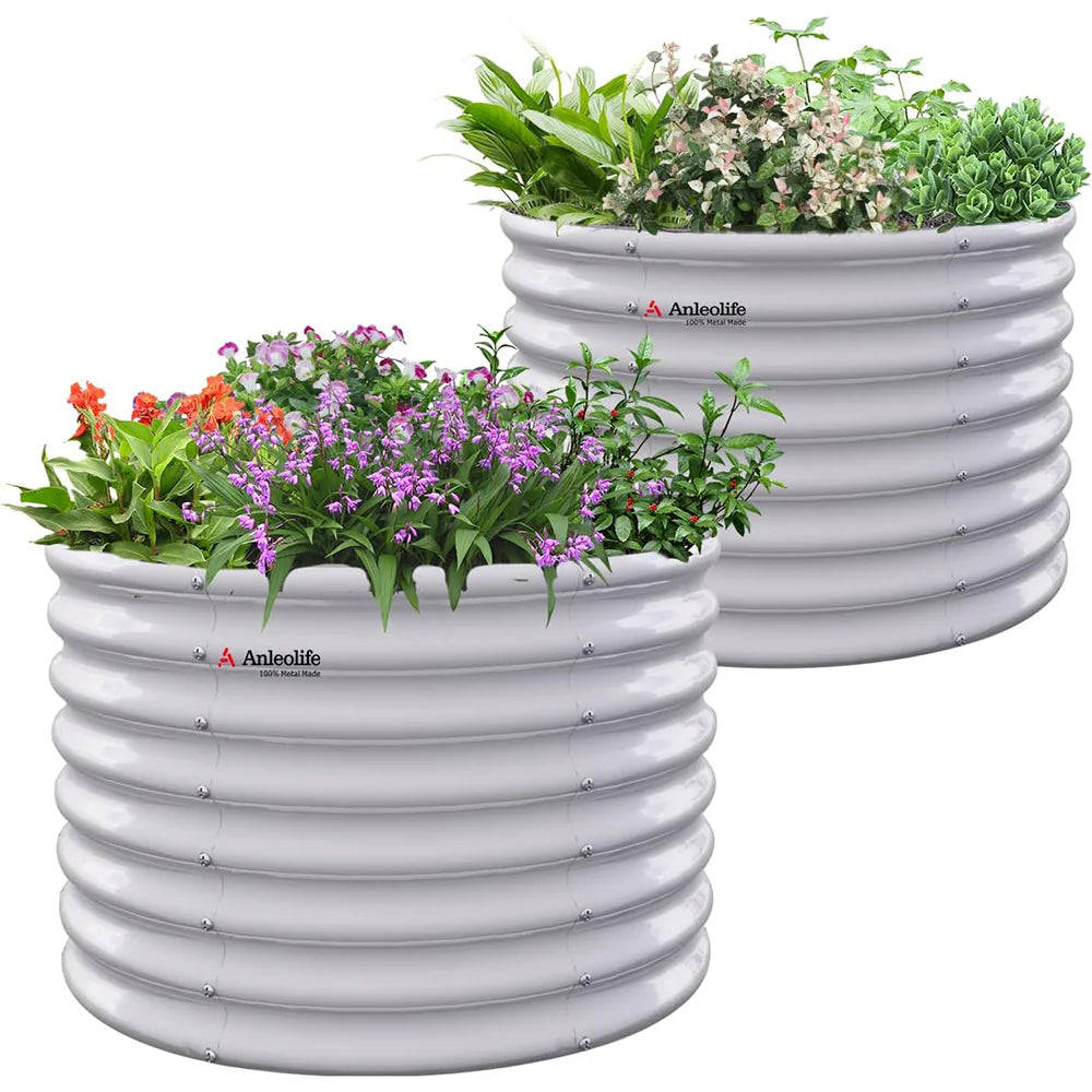 Two white ribbed planters with plants on a white background 
